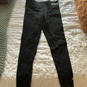 Black leggings with mesh cutouts at bottom